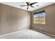 Neutral bedroom with a ceiling fan and a view of a mountain landscape from the window at 3033 W Redwood Ln, Phoenix, AZ 85045