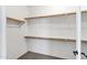 Walk-in closet with wooden shelving and carpeted floors at 3033 W Redwood Ln, Phoenix, AZ 85045
