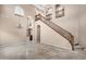 Grand foyer featuring a sweeping staircase and beautiful tile flooring at 3033 W Redwood Ln, Phoenix, AZ 85045