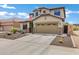 Charming two-story home featuring a tile roof, desert landscaping, and a two car garage at 3033 W Redwood Ln, Phoenix, AZ 85045