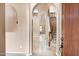 Elegant foyer with arched doorways, tile flooring, and a view of the staircase at 3033 W Redwood Ln, Phoenix, AZ 85045