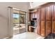 Kitchen area with built in desk, cabinets, and views of the pool at 3033 W Redwood Ln, Phoenix, AZ 85045