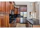 The kitchen features stainless appliances, dark granite counters, and custom cabinetry at 3033 W Redwood Ln, Phoenix, AZ 85045