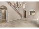 Bright living room featuring tile floors, a chandelier, and arched doorways and windows at 3033 W Redwood Ln, Phoenix, AZ 85045