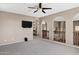 Upstairs loft features carpet, arches, and a mounted television at 3033 W Redwood Ln, Phoenix, AZ 85045