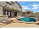 Inviting backyard pool and spa with desert landscaping, covered patio, and a view of the house at 3033 W Redwood Ln, Phoenix, AZ 85045