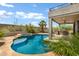 Beautiful backyard pool and spa with desert landscaping, outdoor kitchen, and covered patio space at 3033 W Redwood Ln, Phoenix, AZ 85045