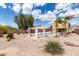 Beautiful backyard featuring a pool, pergola, and desert landscaping under a sunny sky at 309 W Settlers Trl, Casa Grande, AZ 85122