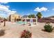 Spacious backyard showcasing a pool, pergola, desert landscaping, and two-story home at 309 W Settlers Trl, Casa Grande, AZ 85122