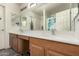 Bathroom featuring a double sink vanity and well lit mirror at 309 W Settlers Trl, Casa Grande, AZ 85122