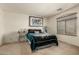 Cozy bedroom featuring plush carpeting, neutral walls, and a window for natural light at 309 W Settlers Trl, Casa Grande, AZ 85122