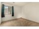 Bedroom with carpeted floors and a window with dark curtains at 309 W Settlers Trl, Casa Grande, AZ 85122