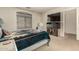Bedroom showcasing natural light, carpeted floors, with a modern entertainment center at 309 W Settlers Trl, Casa Grande, AZ 85122