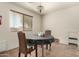 Cozy dining room features a round table with wicker chairs and natural light through window blinds at 309 W Settlers Trl, Casa Grande, AZ 85122