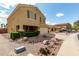 Inviting two-story home featuring a two-car garage, desert landscaping, and a covered front porch at 309 W Settlers Trl, Casa Grande, AZ 85122