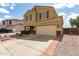 Inviting two-story home featuring a two-car garage, desert landscaping, and a long driveway at 309 W Settlers Trl, Casa Grande, AZ 85122