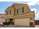 Inviting two-story home featuring a two-car garage, desert landscaping, and a covered front porch at 309 W Settlers Trl, Casa Grande, AZ 85122