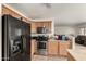 Open-concept kitchen with stainless appliances and light wood cabinetry connects to the living area at 309 W Settlers Trl, Casa Grande, AZ 85122