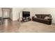 Comfortable living room with tile flooring, a staircase, and a plush brown sofa at 309 W Settlers Trl, Casa Grande, AZ 85122