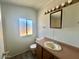 Bathroom featuring a single sink, vanity, toilet, and window for natural light at 320 E Mckellips Rd # 152, Mesa, AZ 85201
