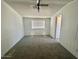This bedroom offers neutral carpeting, a window for natural light, and a ceiling fan at 320 E Mckellips Rd # 152, Mesa, AZ 85201