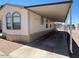 A home with a long carport, ideal for protecting vehicles from the elements at 320 E Mckellips Rd # 152, Mesa, AZ 85201
