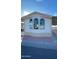 Charming home exterior featuring arched windows and a well-maintained yard, perfect for comfortable living at 320 E Mckellips Rd # 152, Mesa, AZ 85201