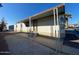 Home with covered porch, steps, and convenient parking, providing easy access and comfortable outdoor space at 320 E Mckellips Rd # 152, Mesa, AZ 85201