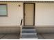 A close-up of the home's entrance, with a small porch, steps and handrails at 320 E Mckellips Rd # 152, Mesa, AZ 85201