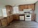 Functional kitchen with wood cabinets, laminate countertops, and modern appliances at 320 E Mckellips Rd # 152, Mesa, AZ 85201