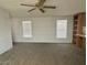 Bright and open living room featuring carpeted floors, two windows, and natural lighting at 320 E Mckellips Rd # 152, Mesa, AZ 85201