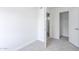 A bright bedroom with neutral carpet, white trim and an open closet at 3222 W Royal Palm Rd, Phoenix, AZ 85051