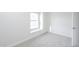 A bright bedroom with a large window and plush carpet flooring at 3222 W Royal Palm Rd, Phoenix, AZ 85051