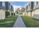 A peaceful community with lush green lawns and well-maintained townhomes under a bright blue sky at 3222 W Royal Palm Rd, Phoenix, AZ 85051