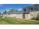View of well-maintained townhomes featuring gated front patios, lush green common areas, and mature shade trees at 3222 W Royal Palm Rd, Phoenix, AZ 85051