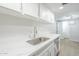 A bright kitchen with white cabinets, stainless steel appliances, and quartz countertops at 3222 W Royal Palm Rd, Phoenix, AZ 85051