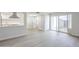 Bright, open-concept living room with modern flooring, and access to the backyard through sliding glass doors at 3222 W Royal Palm Rd, Phoenix, AZ 85051