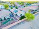 Aerial shot of a cozy home with solar panels, lush landscaping, and a charming backyard patio at 33105 N Double Bar Rd, San Tan Valley, AZ 85144