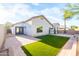 A landscaped backyard features an artificial turf area, brick patio and block wall for privacy at 33105 N Double Bar Rd, San Tan Valley, AZ 85144