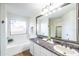 Bathroom with a granite countertop, a large framed mirror, and a soaking tub by the window at 33105 N Double Bar Rd, San Tan Valley, AZ 85144