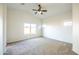 Spacious bedroom with plush carpet, a ceiling fan, and plenty of natural light from the windows at 33105 N Double Bar Rd, San Tan Valley, AZ 85144