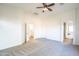 Bright bedroom with vaulted ceiling, neutral carpet, a ceiling fan, and multiple entryways at 33105 N Double Bar Rd, San Tan Valley, AZ 85144