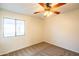 Comfortable bedroom with carpet, a ceiling fan, and a bright window to the outside at 33105 N Double Bar Rd, San Tan Valley, AZ 85144