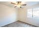 Cozy bedroom featuring carpet, a ceiling fan, and a bright window providing natural light at 33105 N Double Bar Rd, San Tan Valley, AZ 85144