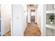 Hallway with tile flooring that leads to rooms with white doors, and view to a window in another room at 33105 N Double Bar Rd, San Tan Valley, AZ 85144
