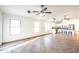 Bright living room showcasing a tile floor, multiple windows, and an open layout adjacent to the kitchen area at 33105 N Double Bar Rd, San Tan Valley, AZ 85144
