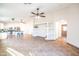Spacious living room features an open layout with tile flooring, ceiling fan, and a decorative built-in shelving unit at 33105 N Double Bar Rd, San Tan Valley, AZ 85144
