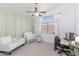 Bright bedroom with ample natural light, ceiling fan, a crib, and a modern chair at 341 E Constitution Dr, Gilbert, AZ 85296