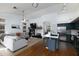 Expansive living area with fireplace, kitchen island and stainless appliances, and comfortable seating at 341 E Constitution Dr, Gilbert, AZ 85296