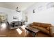 Spacious open-concept living and dining area featuring hardwood floors, modern furniture and plenty of sunlight at 341 E Constitution Dr, Gilbert, AZ 85296